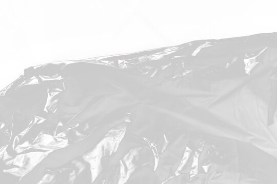 Crumpled Transparent Plastic Film Texture Background with Smooth Glossy Folds and Copy Space