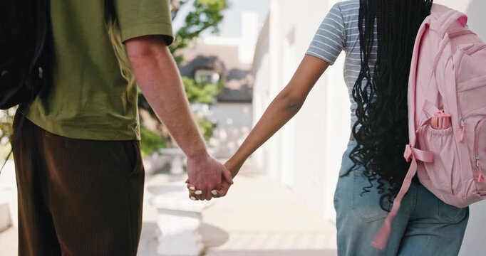 College, student or couple on campus with holding hands, connection or bonding in study opportunity. Walk, back or people with bag, romantic moment or academic development in university relationship.