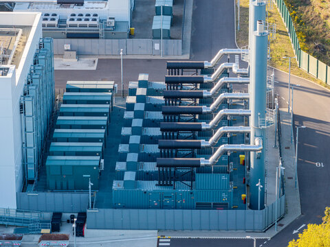 Aerial view of the Vantage Data Centers - BER1 facility featuring rows of industrial power generators and exhaust systems in Ludwigsfelde, Brandenburg, Germany.