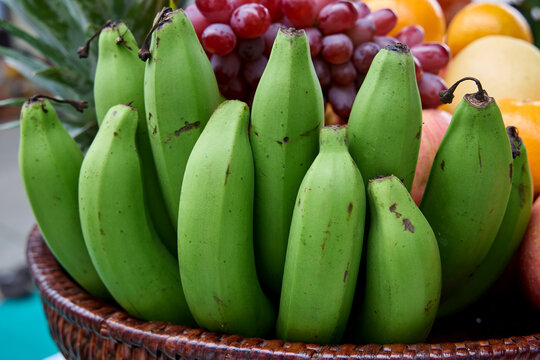 Close up of green bananas in a fruit basket