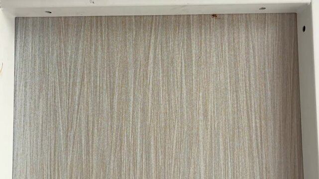 Close up footage of a modern desk with white metal frame and light wood grain surface