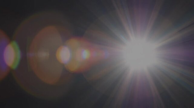 Cinematic lens flares with vibrant light leaks during a subtle camera pull back against a dark background