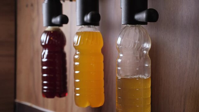 A counter with a tap for beer. The beer is served in plastic containers. There are three varieties of beer available in these disposable containers.