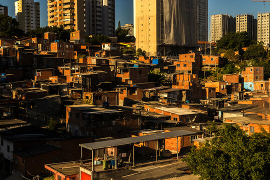 An aerial detailed view of the crowded Morro do Piolho favela community (also known as Sonia Ribeiro) composed of brick houses next to the Roberto Marinho Avenue 