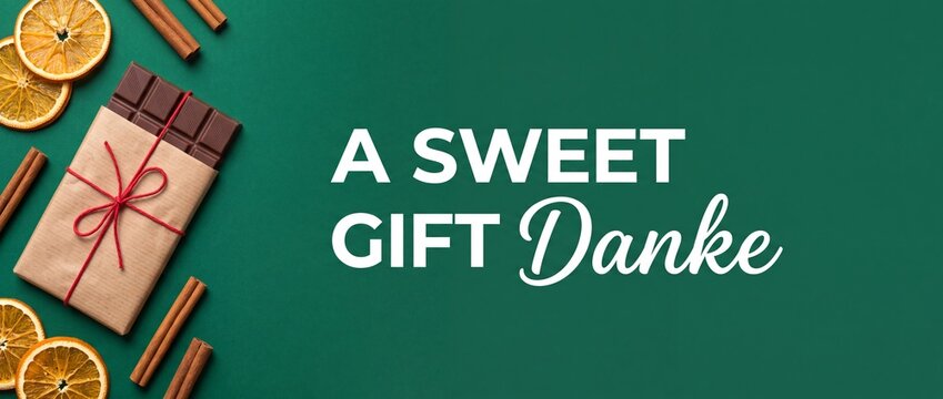 Chocolate gift bar wrapped paper on green background with dried orange slices and cinnamon sticks for danke thank you greeting card concept banner with copy space for festive holiday sweet present