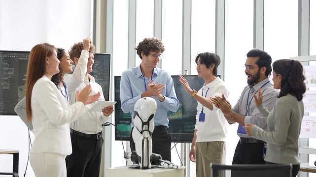 Excited office tech team cheers and pumps fists after a successful robotic arm demo beside a humanoid robot, as the team compares results, an agentic AI and automation concept