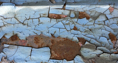 Peeling blue paint revealing rusted metal texture © Lovec1