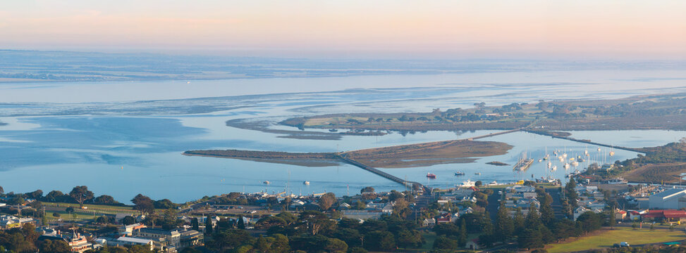 Aerial panorama view of a sheltered bay around an island and a coastal town