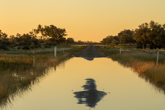 Water over the road on remote single lane bitumen