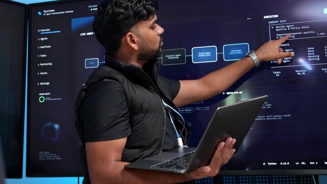 Developer analyzes code on laptop in tech lab