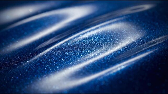High-end automotive paint pigments shimmer beneath a deep cobalt-blue translucent coating, forming abstract material background
