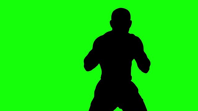 Black silhouette of boxer man on green background. Medium shot of a sport concept with chroma key green screen.