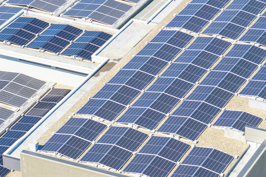 Aerial view of solar panels installed on a flat commercial rooftop in Arezzo, Tuscany, Italy.