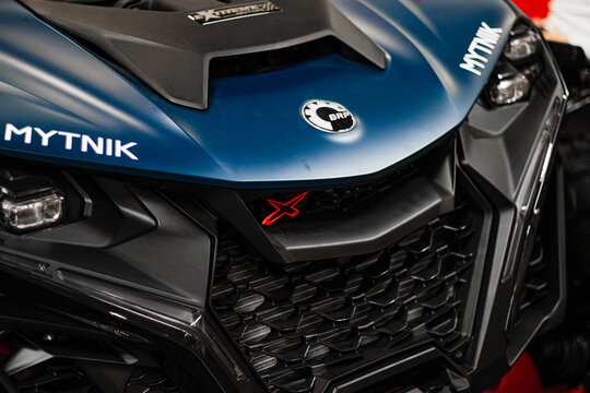 Krakow, Polska - September 06, 2026: Close up of blue Can Am Maverick X3 off road vehicle front with black grille, BRP emblem, headlights and MYTNIK branding
