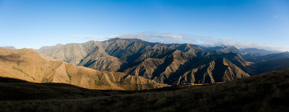 Sunlight hitting the peaks of a vast mountain range