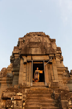Woman in a colorful dress at an ancient temple doorway
