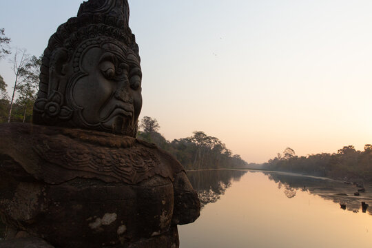 Ancient stone guardian statue at a temple in Cambodia