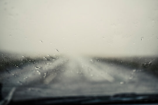 View through a car windshield on a rainy day