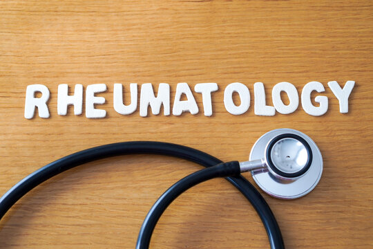 The word rheumatology spelled out in wooden letters, accompanied by a black medical stethoscope.