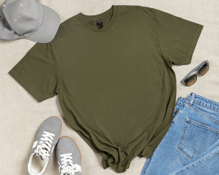 Blank military green unisex t-shirt mockup, crewneck flat lay with denim jeans and mens accessories