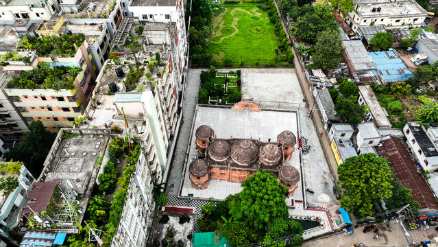 Aerial view of the historic Khan Mohammad Mridha Mosque surrounded by dense urban rooftops and greenery in Dhaka, Dhaka Division, Bangladesh.