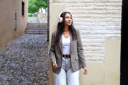 Woman wandering through ancient streets with thoughtful expression and heritage ambiance