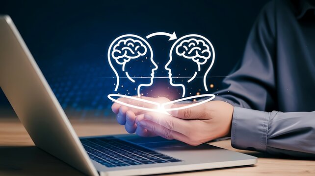 Concept of knowledge transfer, communication and empathy with hands holding virtual brain icons in front of a laptop