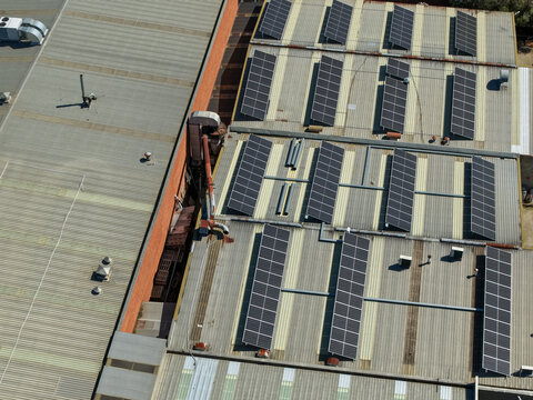 Aerial view of industrial factory rooftops featuring extensive solar panel arrays and ventilation systems in Kilsyth, Victoria, Australia.