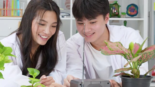 Teenage Students Conducting Science Experiment with Plants and Radio