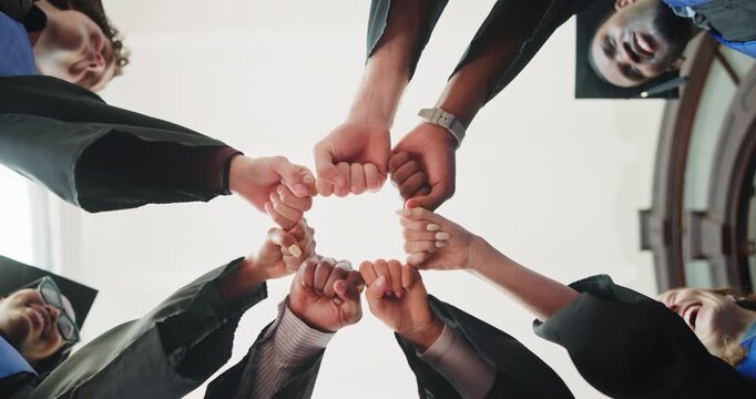 Below, graduation and students in circle with fist bump, education milestone and community upskill. People, hands together and happy on campus for university achievement, class success or opportunity