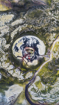 Aerial view of a volcanic crater Stutur with dark lava flows and vibrant green mossy terrain in Iceland.