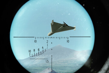A military drone flies over mountains and is tracked in a targeting surveillance system. © Ernest