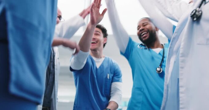 People, doctor or meeting with hands together in hospital for winning, achievement or success. Low angle, medical team or piling with smile, applause or collaboration for healthcare mission in clinic