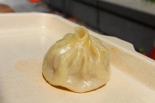 A beef momo (Tibetan beef dumpling) served at a street food stall