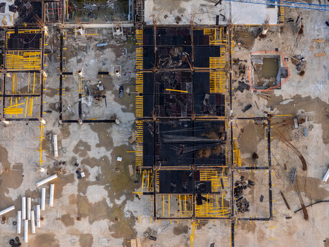 Aerial view of a construction site with concrete foundations, steel reinforcement bars, and wooden formwork in Santo Domingo Este, Santo Domingo Provinc, Dominican Republic.