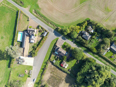 Interesting drone view of a once small, British railway station and platform now converted to a private house. A single railway carriage can be seen next to the outdoor pool, on part of the platform.