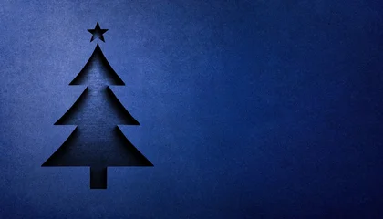 A stylized 3D Christmas tree emblem, cut from a blue-painted concrete surface, featuring crisp edges, subtle shading, and a rough texture. © ginettigino