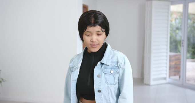 High speed photography for dynamic scenes, woman in denim jacket looking down with thoughtful expres