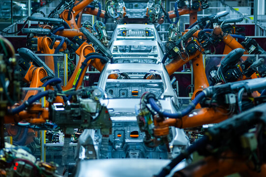 Automated Automotive Welding Production Line with Industrial Robots Processing Car Body in White in Modern Smart Factory
