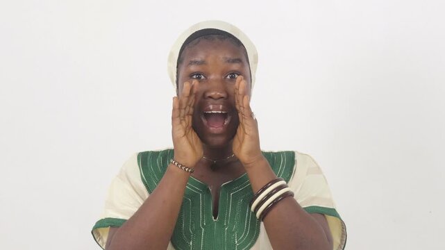 Young African woman shouting with her hands around her mouth, making an announcement gesture.