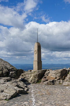 Stone Summit Monument on Je&scaron;těd Mountain Peak in Liberec under Blue Sky with Clouds for Travel Concept