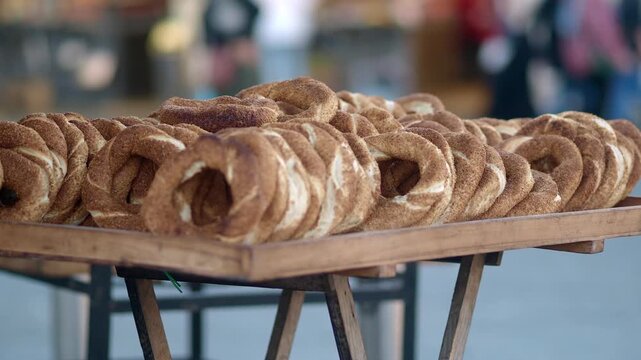 A wooden tray filled with traditional turkish bagels known as simit ready for sale.