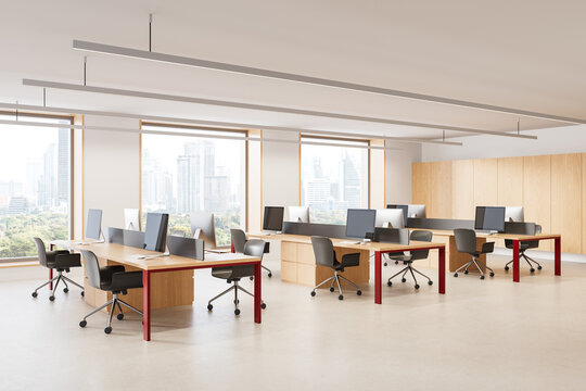 Modern open plan office interior with collaborative workstations, computers, pendant lighting, and panoramic city windows in a bright contemporary workplace. 3D Rendering