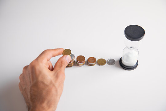 Man showing hourglass with a coins.