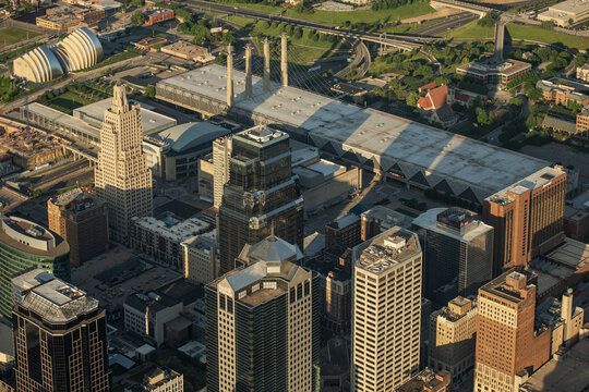 Aerial view of the downtown skyline featuring the Power and Light Building and the Kansas City Convention Center under warm sunlight in Kansas City, Missouri, United States.