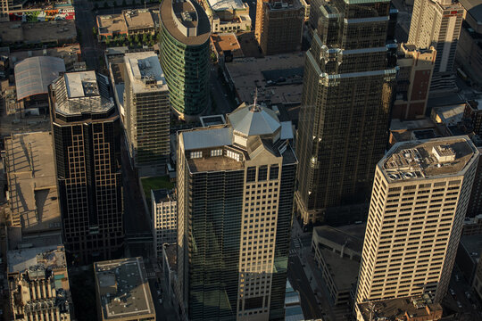 Aerial view of the Kansas City skyline featuring modern skyscrapers, glass office buildings, and urban streets during the golden hour in Kansas City, Missouri, United States.