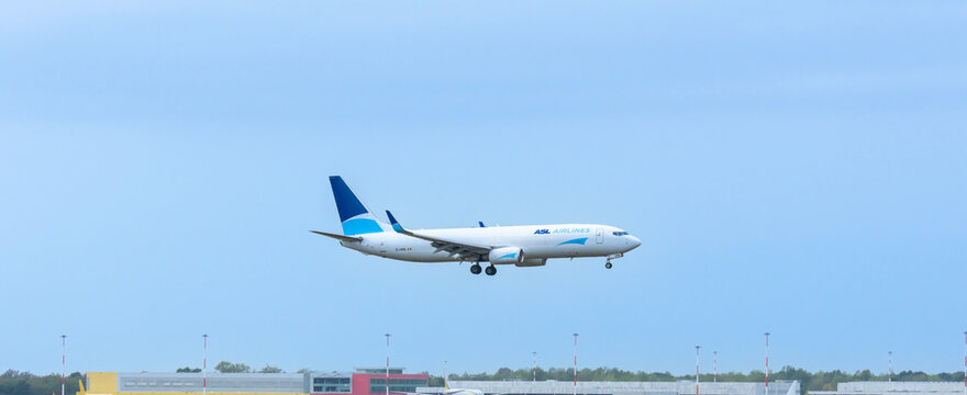 Side profile of an ASL Airlines Boeing 737-800 freighter cargo aircraft on landing approach at Milan Malpensa Airport (MXP)