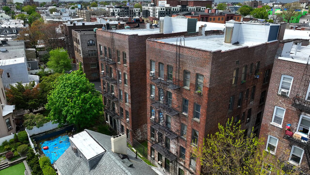 Aerial view of brick apartment buildings with fire escapes in a residential neighborhood in Weehawken, New Jersey, United States.