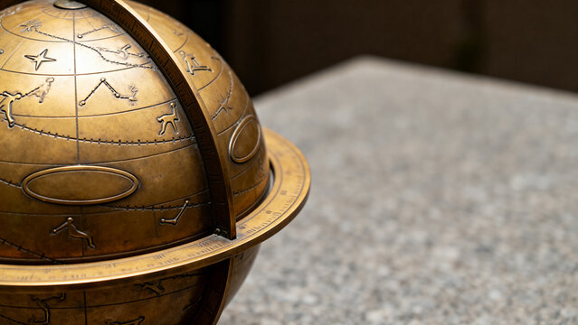 Vintage brass armillary sphere on stone table, astronomy and antique navigation concept