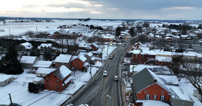 Aerial view of West Lampeter Township featuring snow-covered residential houses, local roads, and winter fields in Lampeter, Pennsylvania, United States.